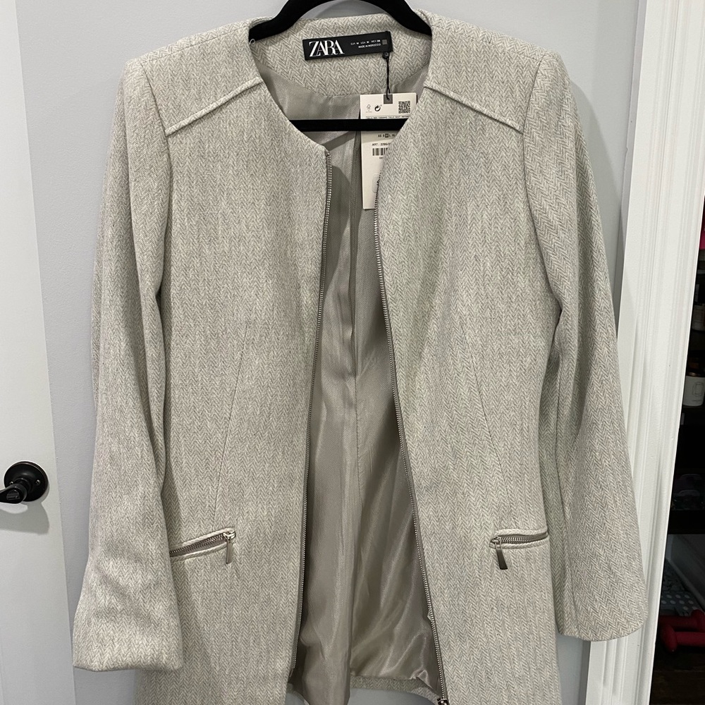 Silver/gray blazer/jacket with silver zippers. New with tags!